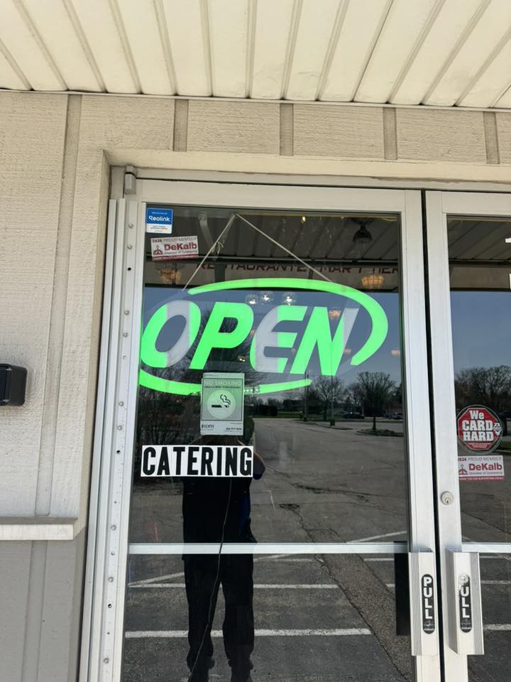 Nina's Tacos storefront with OPEN sign and Catering decal