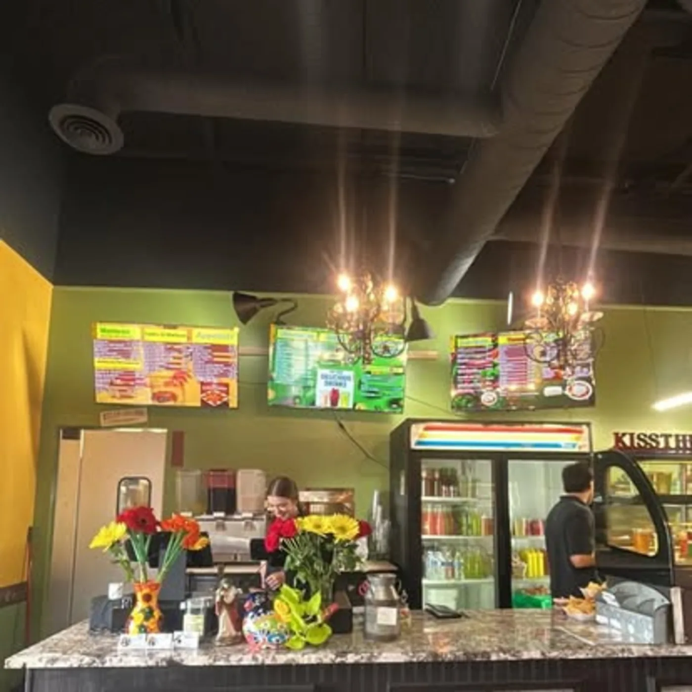 Colorful interior counter and dining room at Nina's Tacos