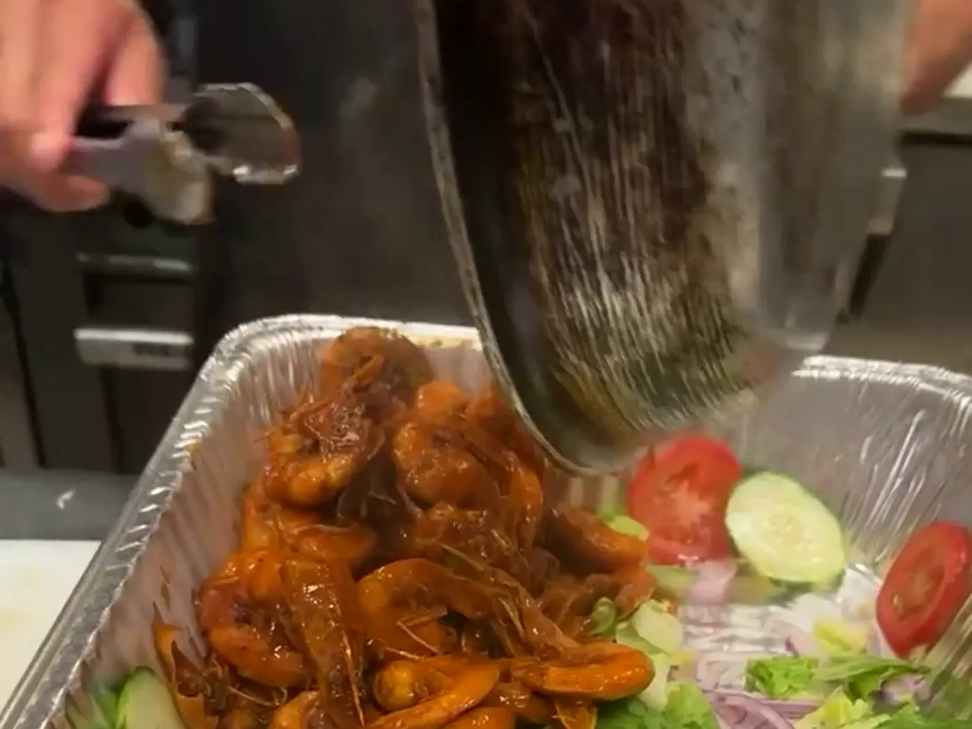 Sauced shrimp mariscos tray being prepared at Nina's Tacos